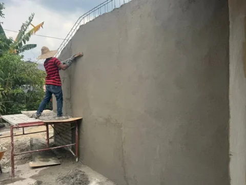 Kerja melepa dan kemasan dinding di tapak projek